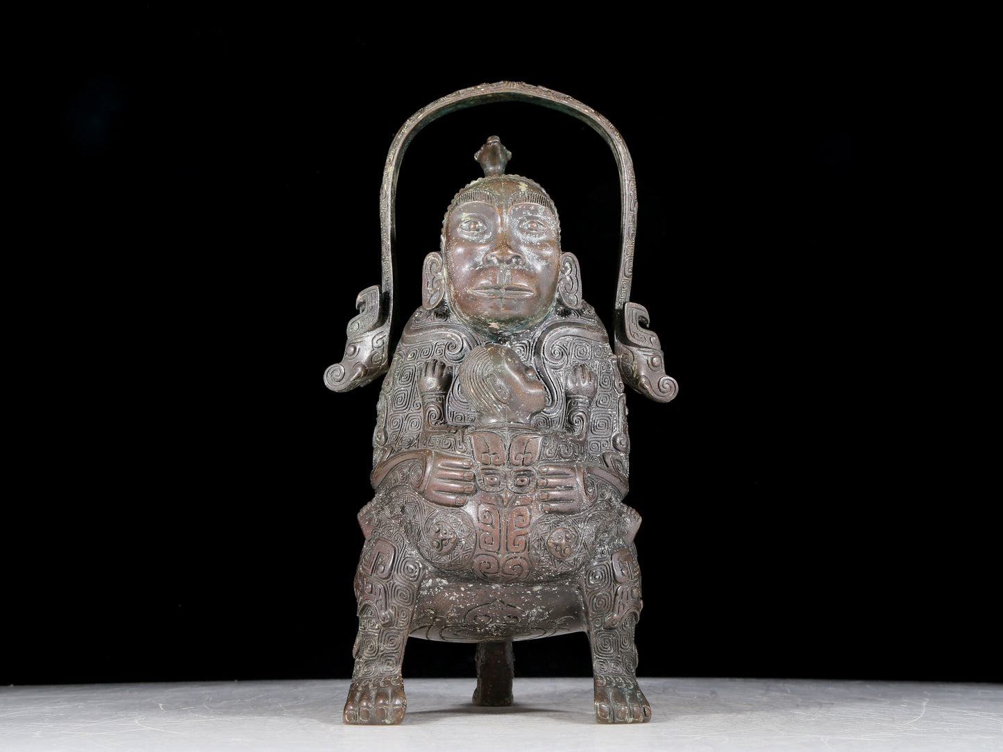 A precious bronze figure carrying a kettle