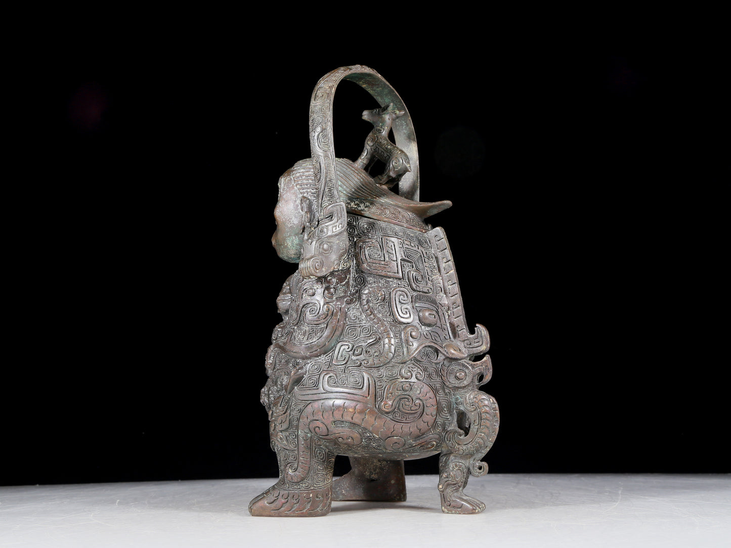 A precious bronze figure carrying a kettle