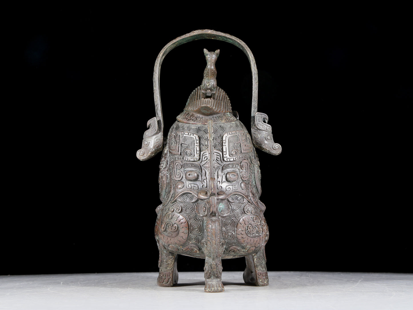 A precious bronze figure carrying a kettle