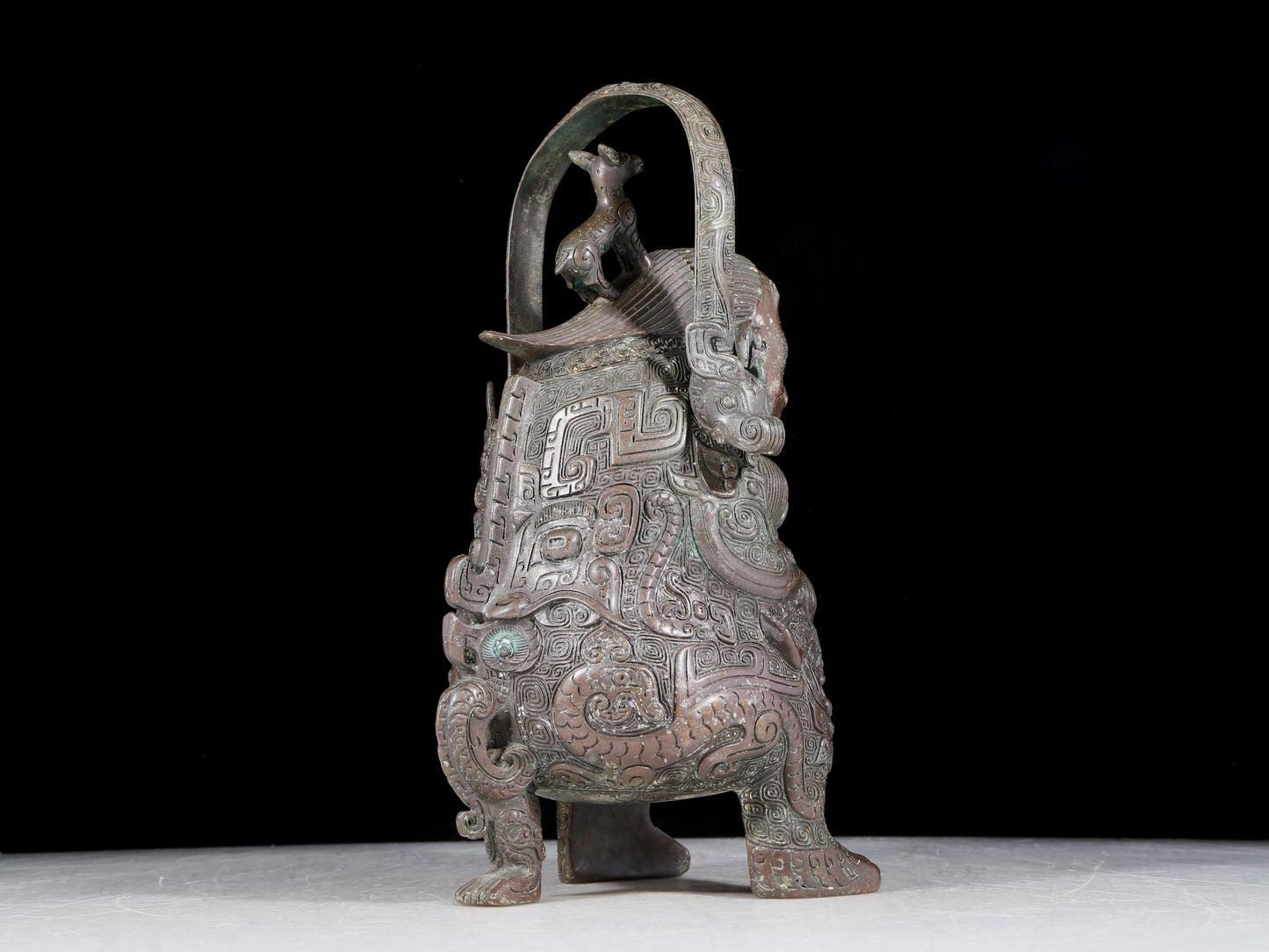 A precious bronze figure carrying a kettle