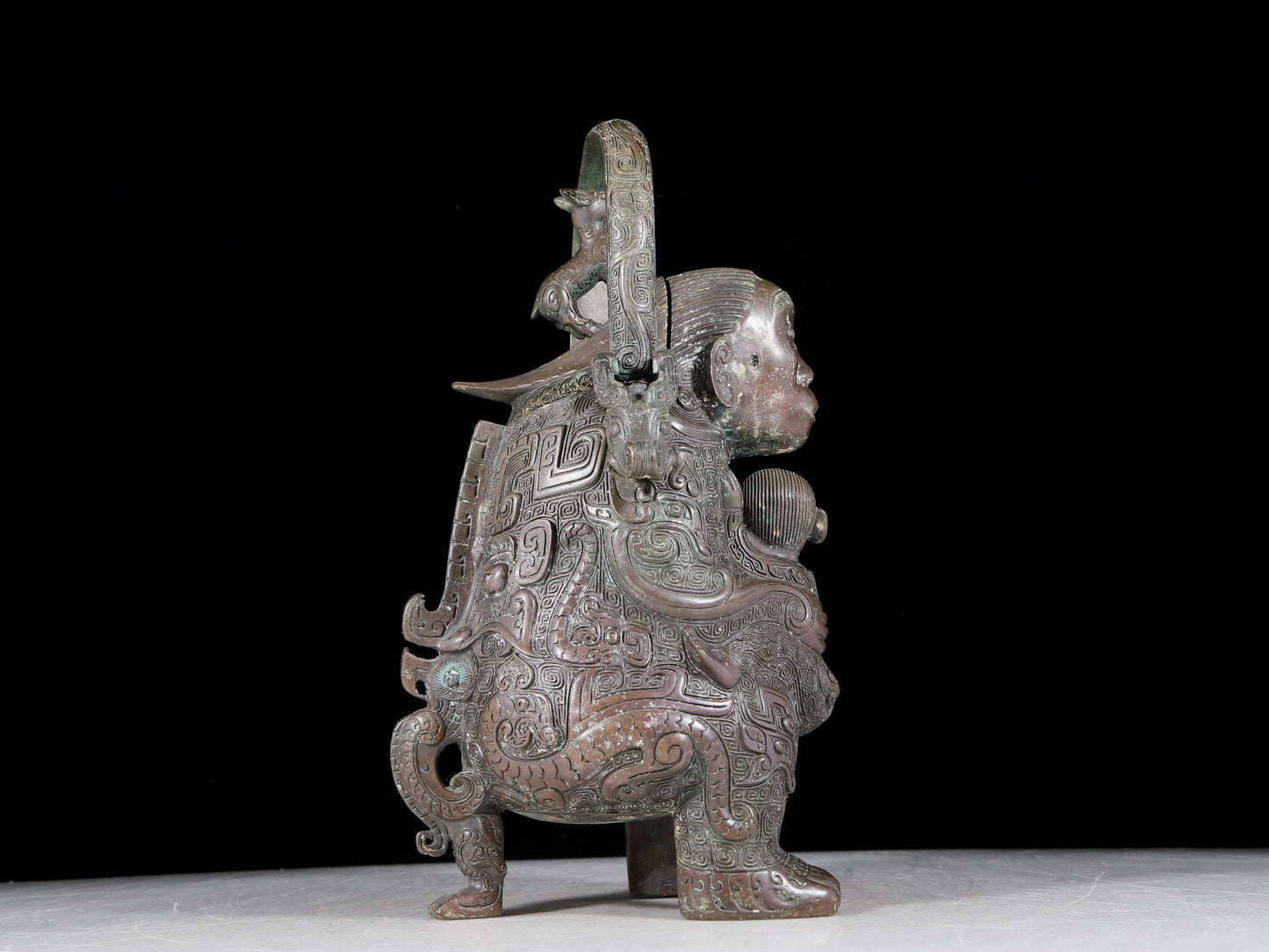 A precious bronze figure carrying a kettle