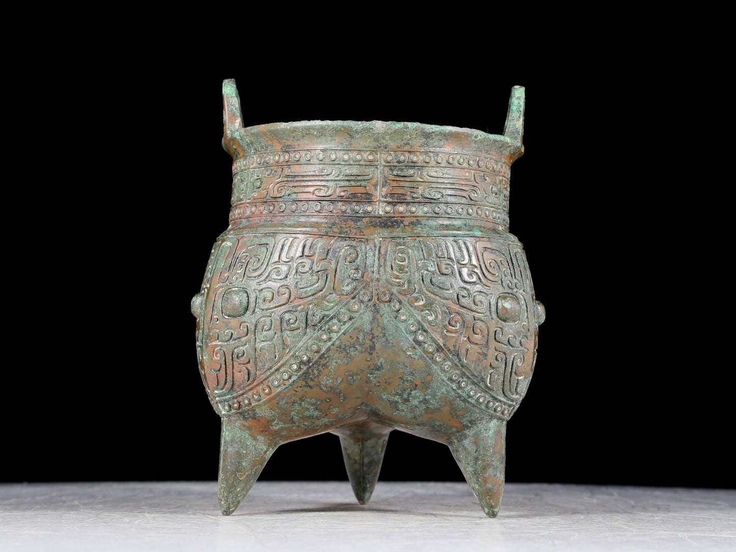 A precious bronze animal-faced two-eared and tripod furnace