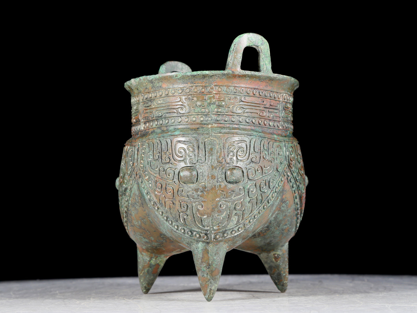 A precious bronze animal-faced two-eared and tripod furnace