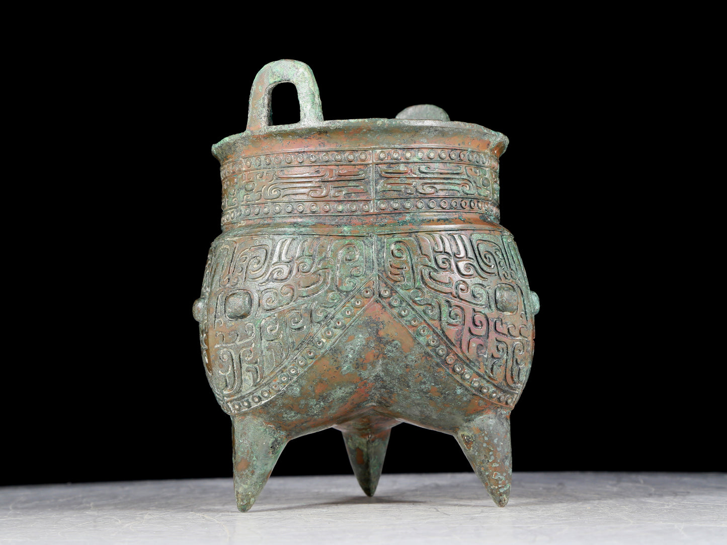 A precious bronze animal-faced two-eared and tripod furnace