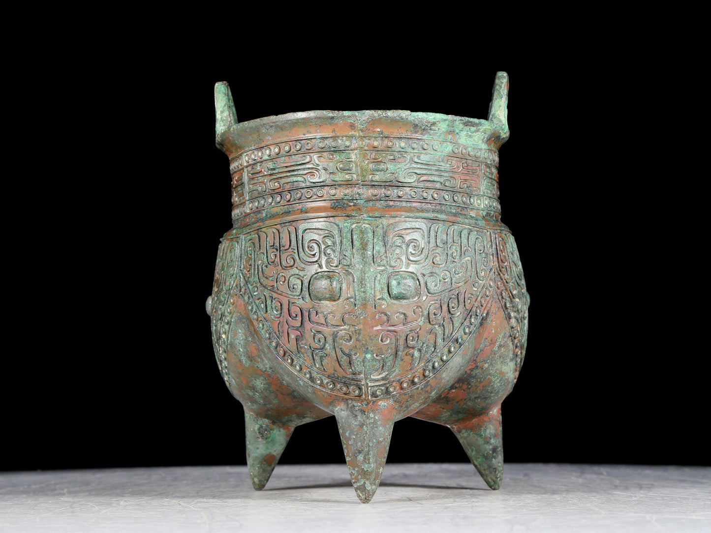 A precious bronze animal-faced two-eared and tripod furnace