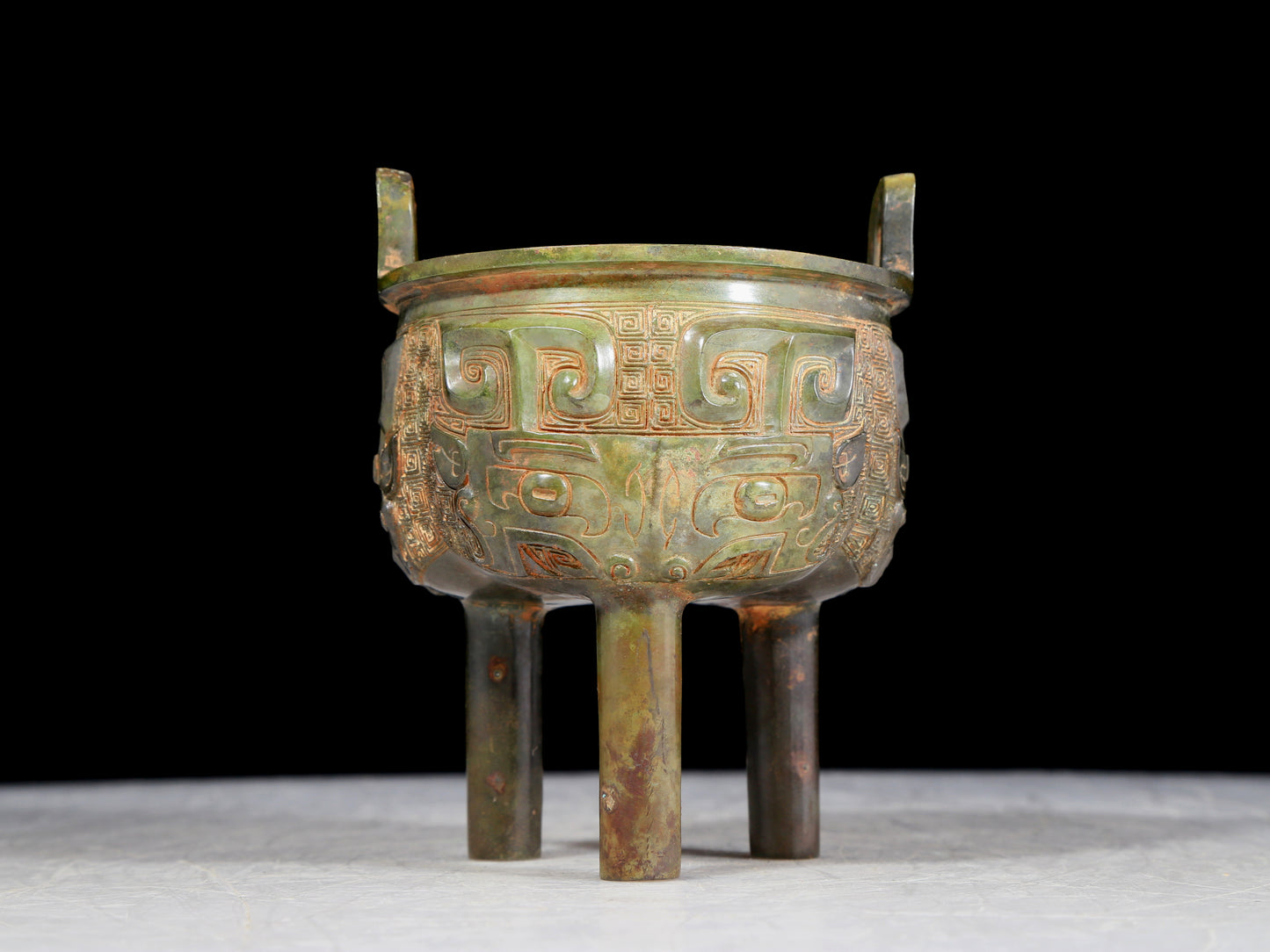 A precious bronze animal-faced two-eared and tripod furnace