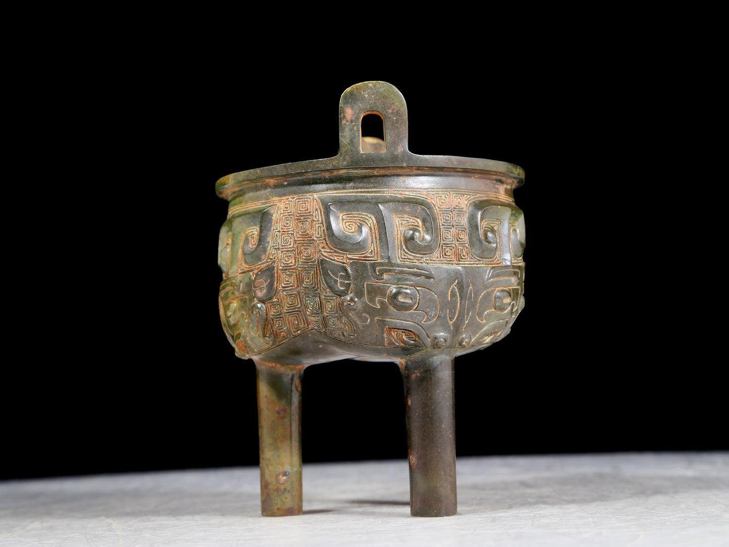 A precious bronze animal-faced two-eared and tripod furnace