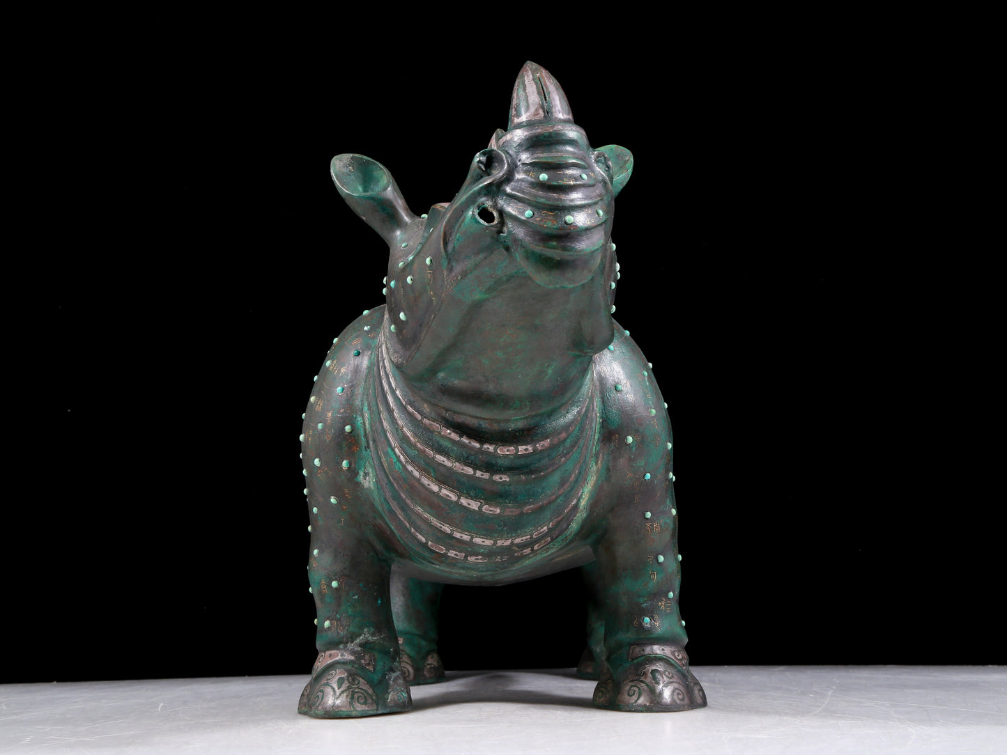 A precious bronze rhinoceros jar inlaid with gold and silver