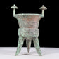 A precious bronze tripod cup with animal masks