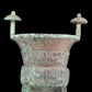 A precious bronze tripod cup with animal masks