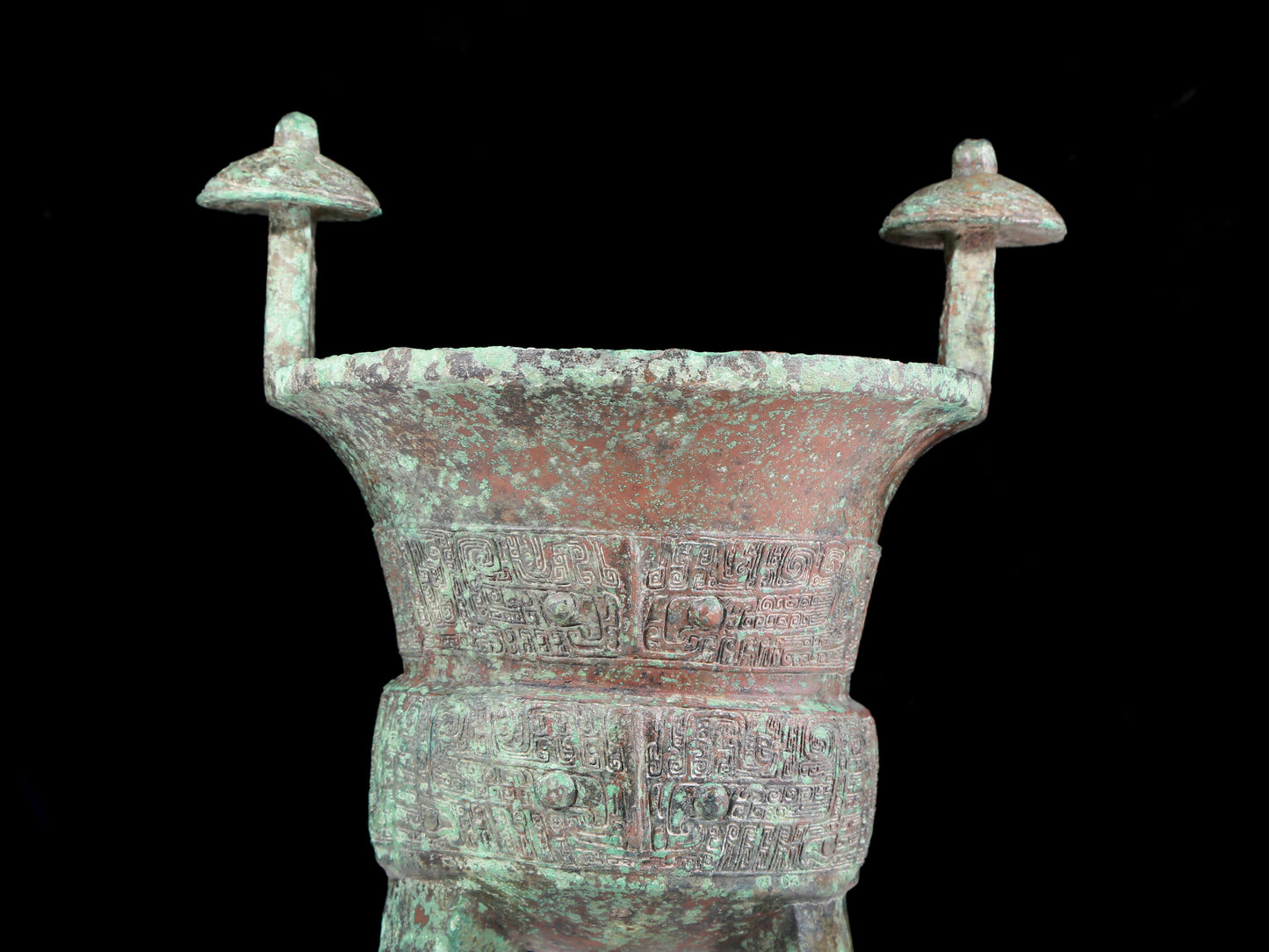 A precious bronze tripod cup with animal masks