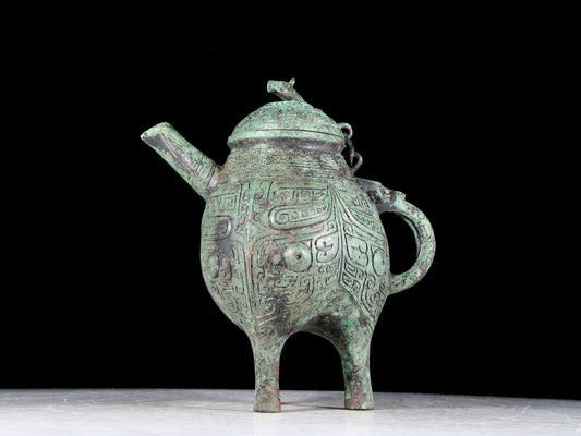 A precious bronze tripod ewer with animal masks