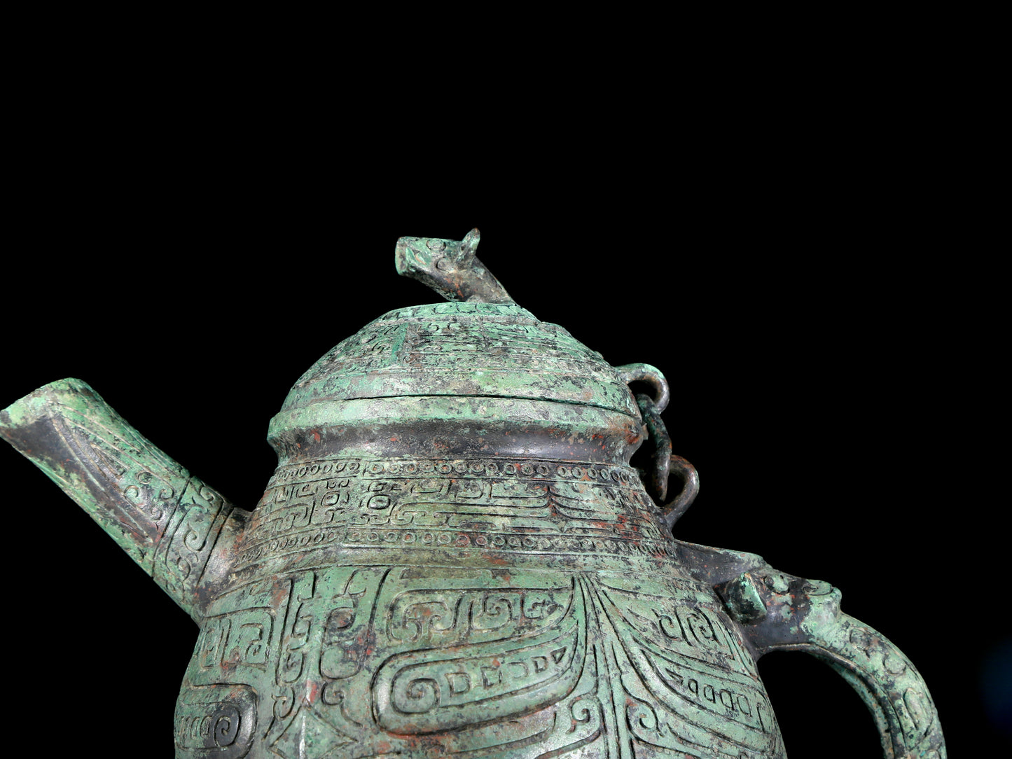 A precious bronze tripod ewer with animal masks