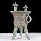 A precious bronze tripod cup with animal masks