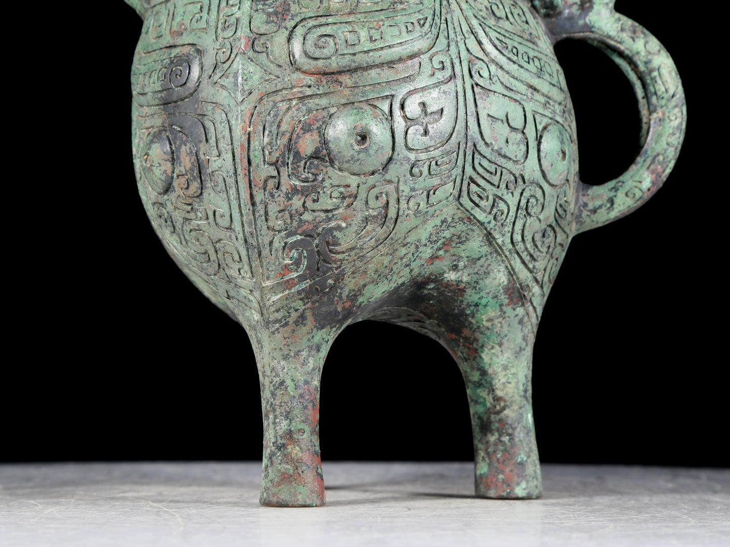 A precious bronze tripod ewer with animal masks