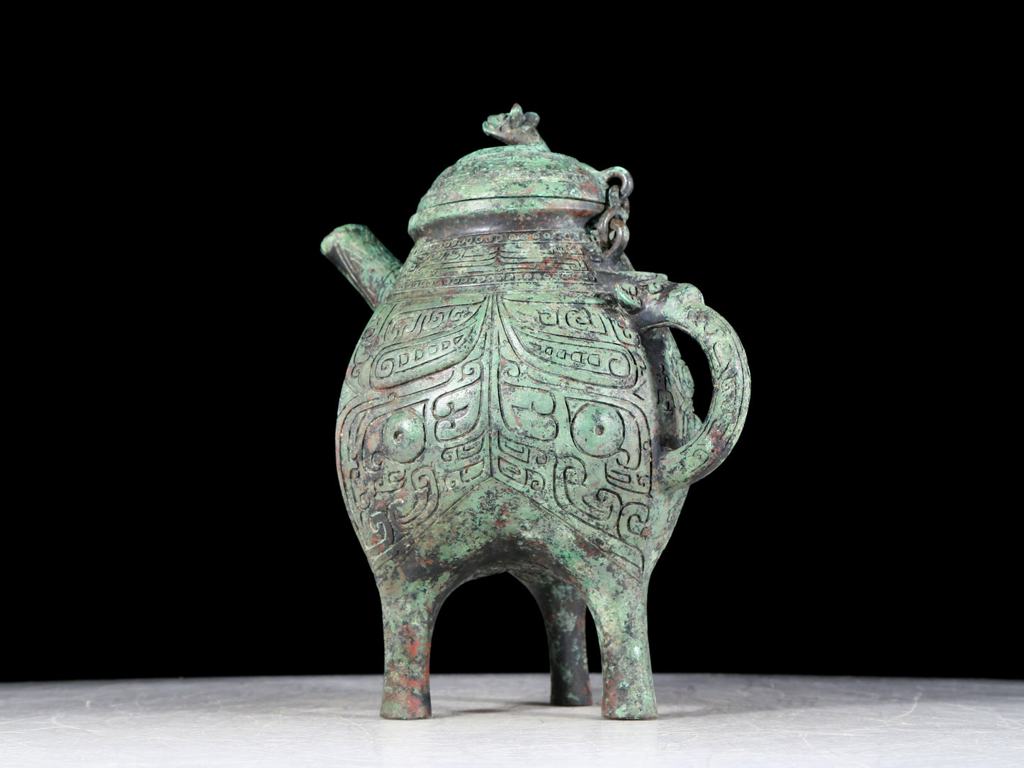 A precious bronze tripod ewer with animal masks