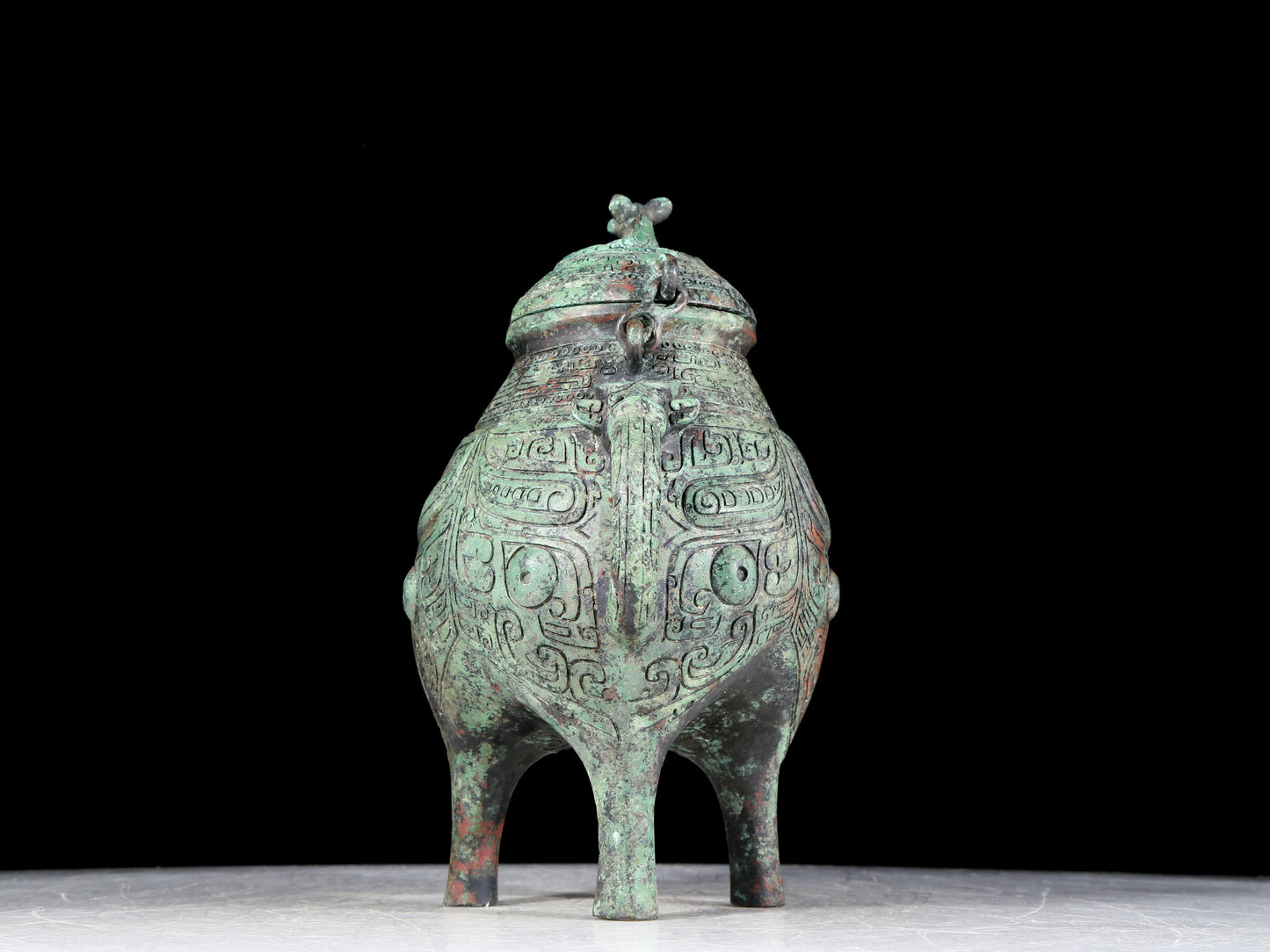 A precious bronze tripod ewer with animal masks