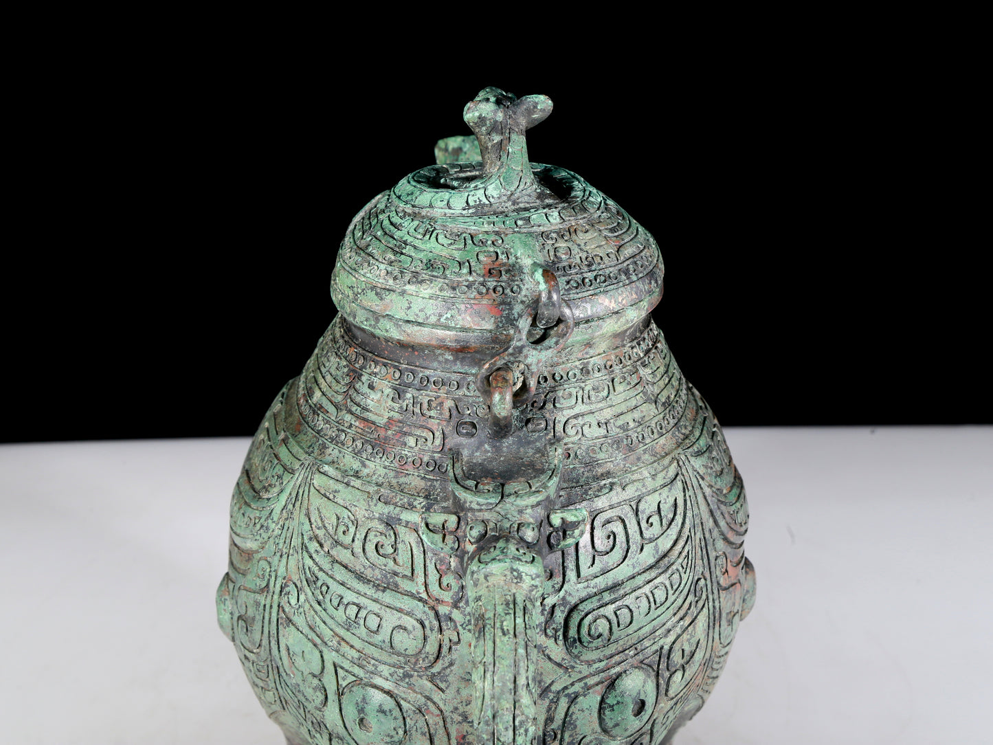 A precious bronze tripod ewer with animal masks