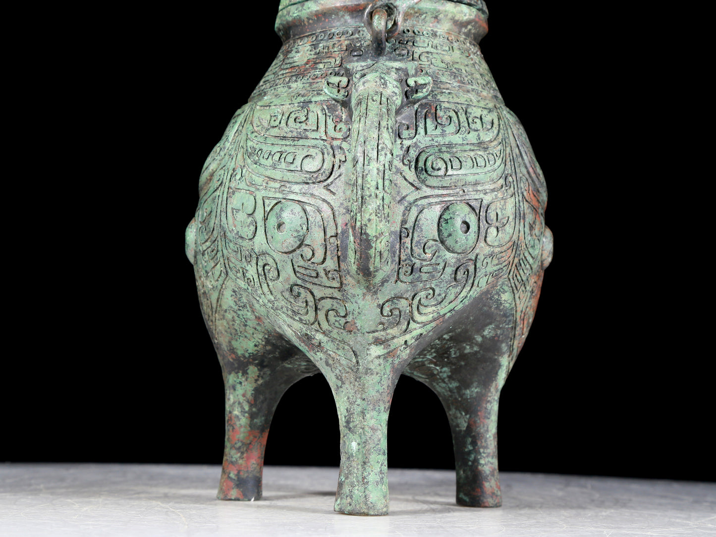 A precious bronze tripod ewer with animal masks