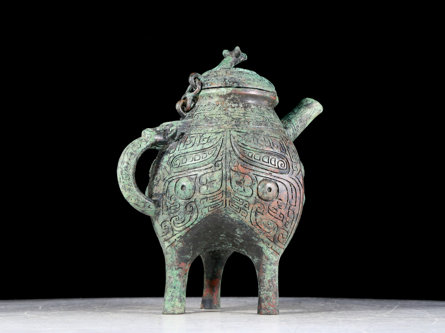 A precious bronze tripod ewer with animal masks