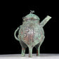 A precious bronze tripod ewer with animal masks