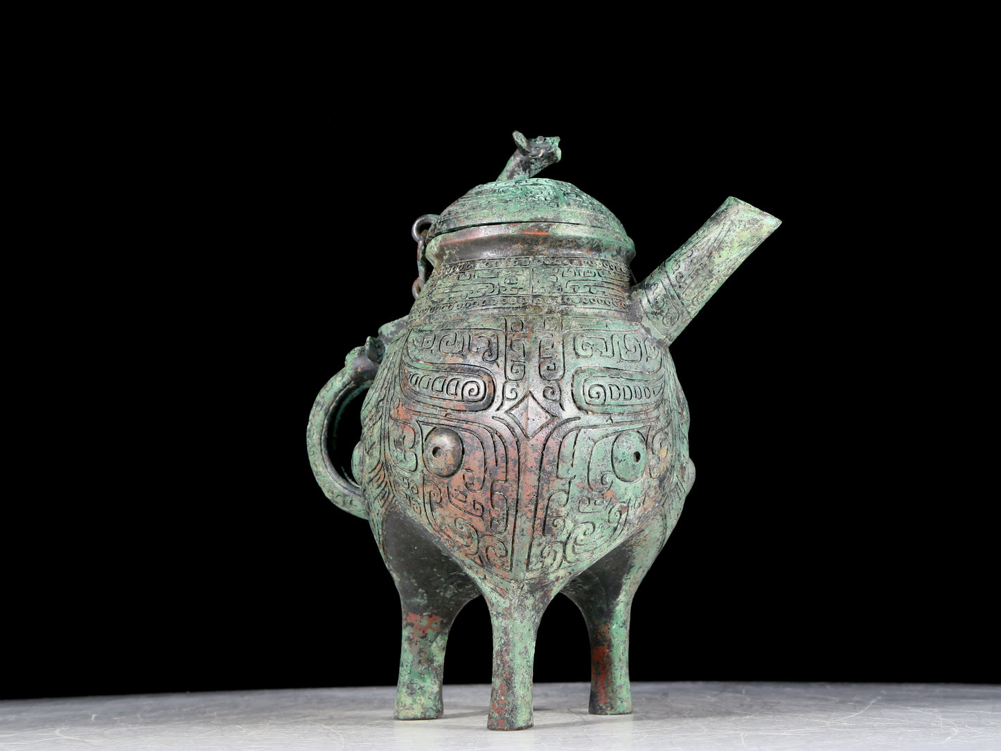 A precious bronze tripod ewer with animal masks