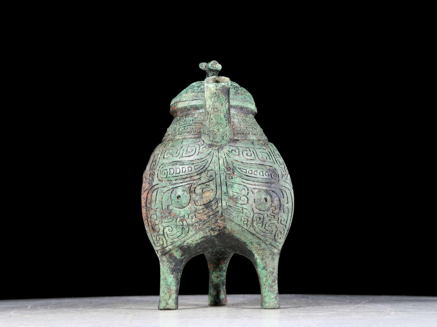 A precious bronze tripod ewer with animal masks