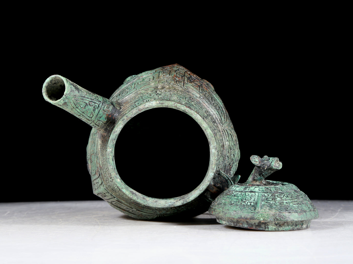 A precious bronze tripod ewer with animal masks