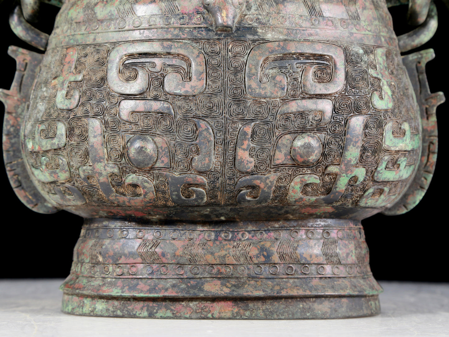 A precious bronze animal-faced pot