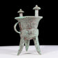 A precious bronze tripod cup with animal masks