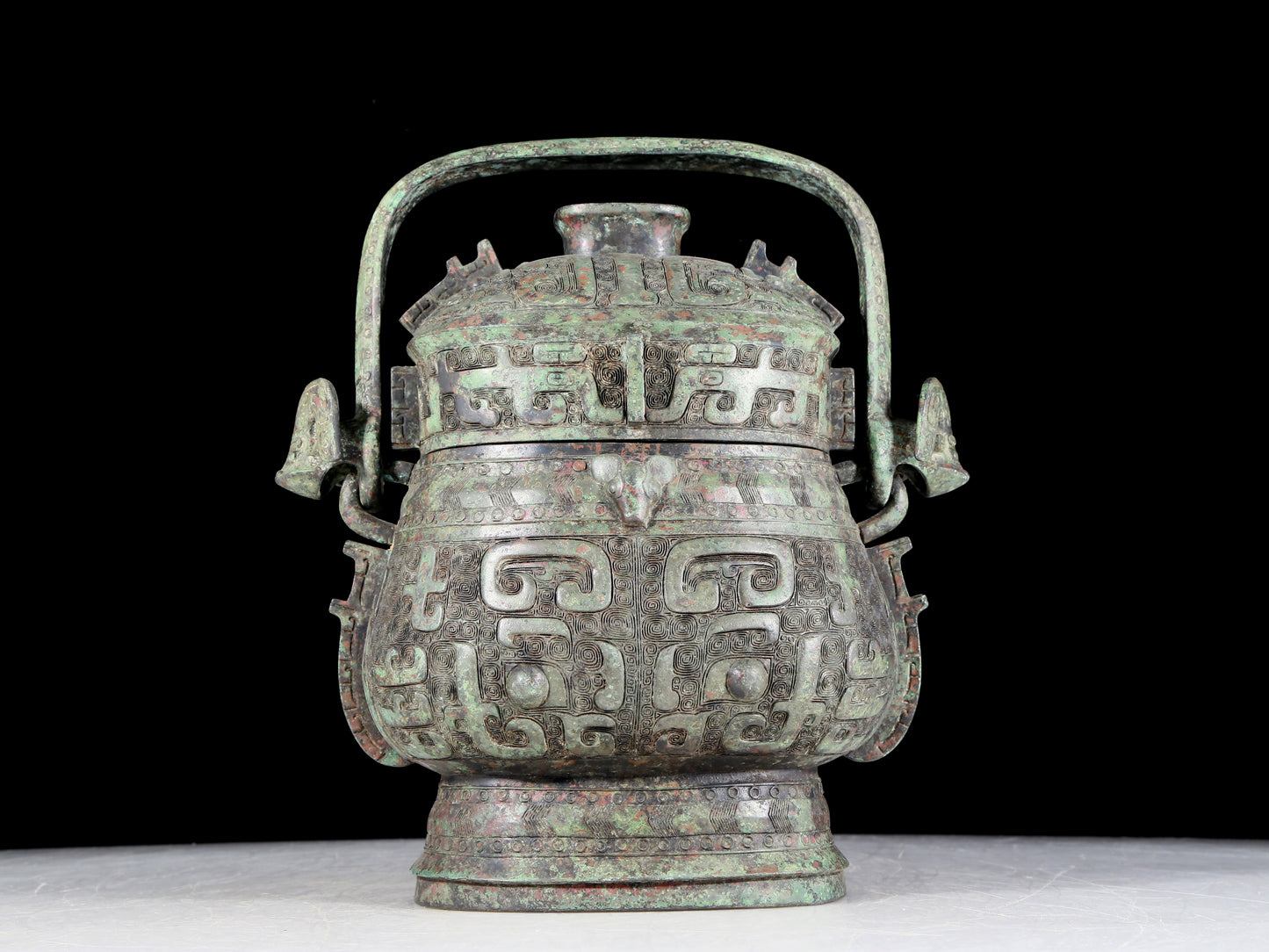 A precious bronze animal-faced pot