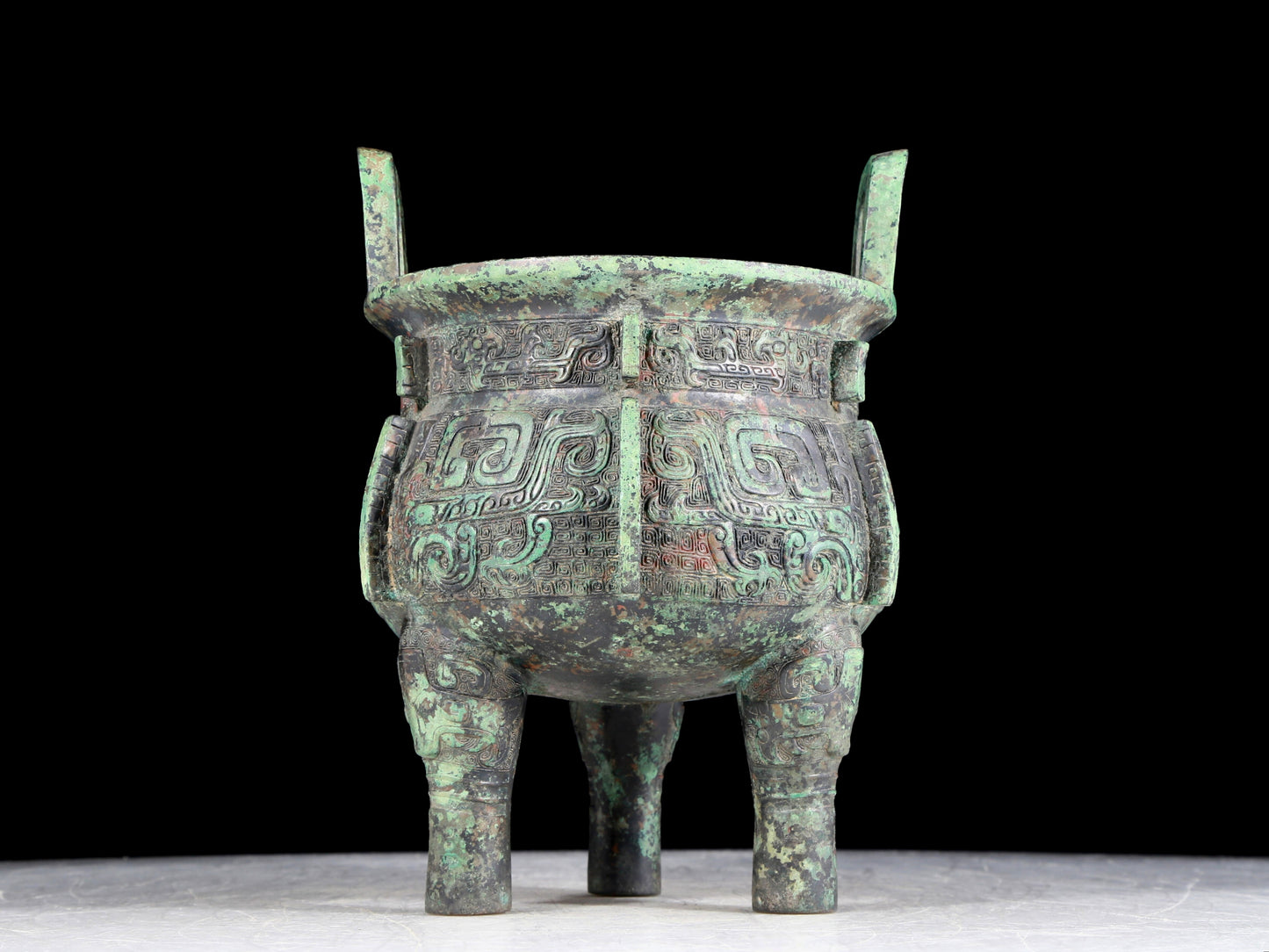 A precious bronze animal-faced two-eared and tripod furnace