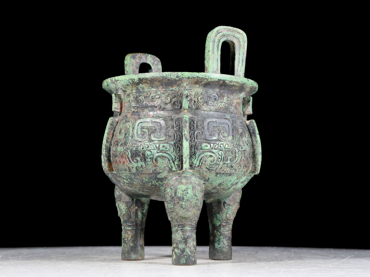 A precious bronze animal-faced two-eared and tripod furnace