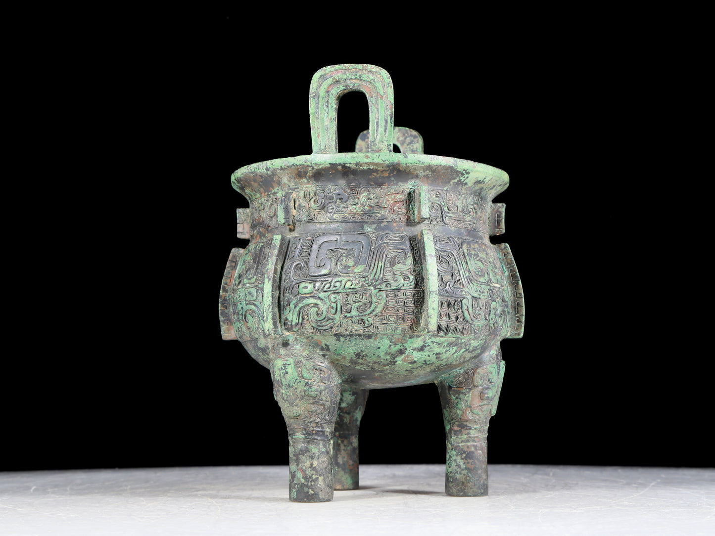 A precious bronze animal-faced two-eared and tripod furnace