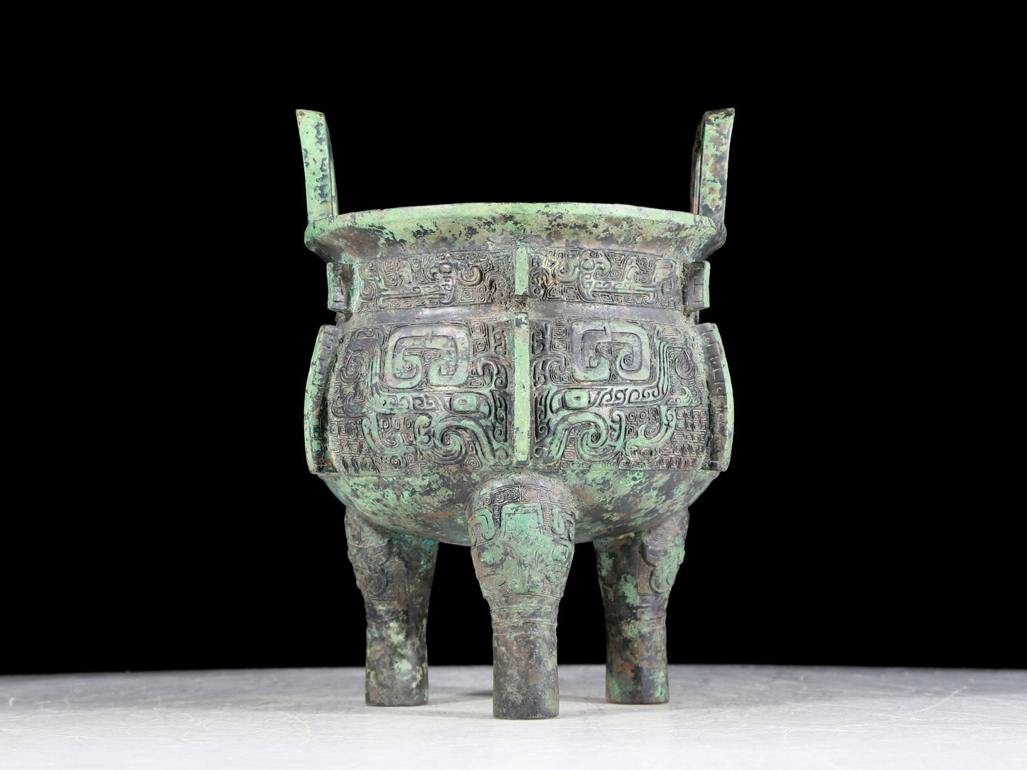 A precious bronze animal-faced two-eared and tripod furnace