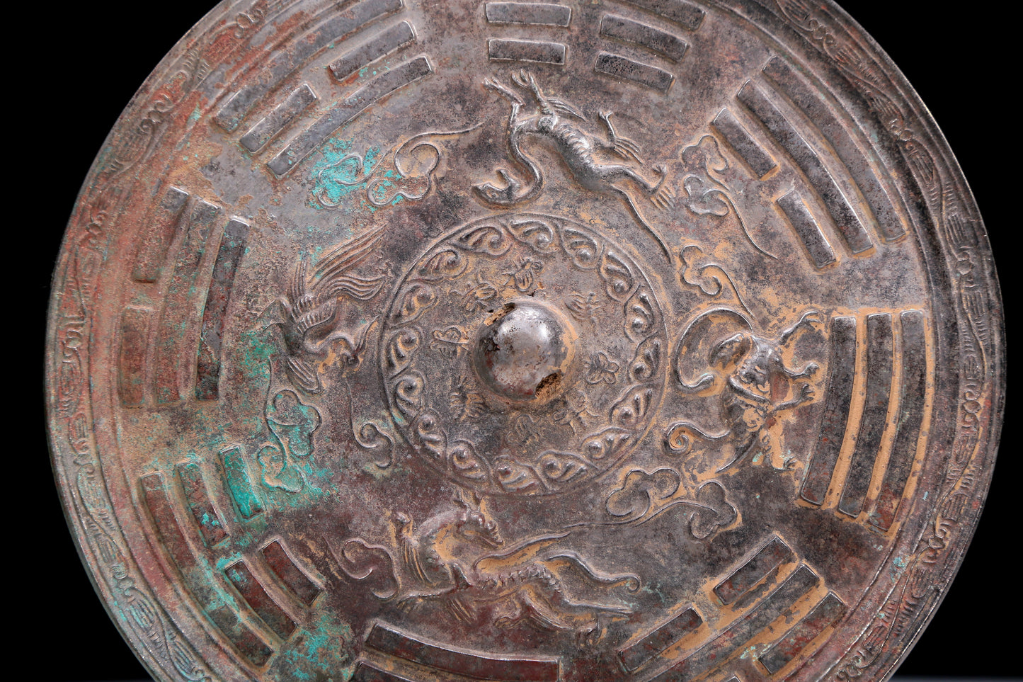 An Archaic Circular Bronze 'Auspicious Beast, Auspicious Cloud, The Eight Diagrams' Mirror