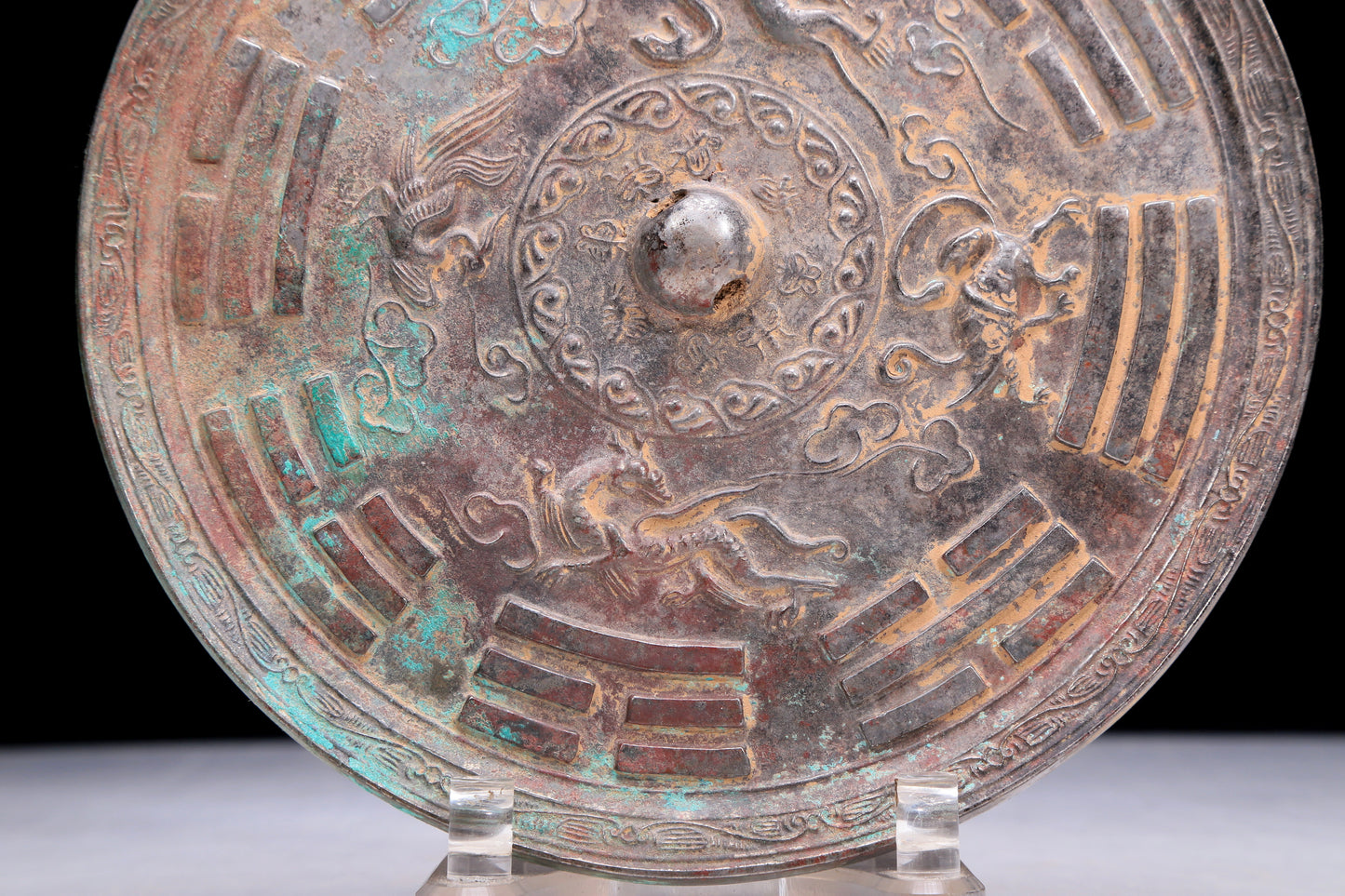 An Archaic Circular Bronze 'Auspicious Beast, Auspicious Cloud, The Eight Diagrams' Mirror