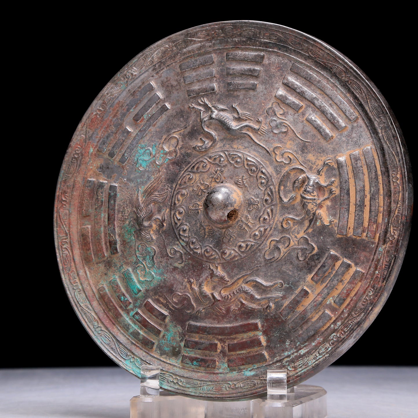 An Archaic Circular Bronze 'Auspicious Beast, Auspicious Cloud, The Eight Diagrams' Mirror