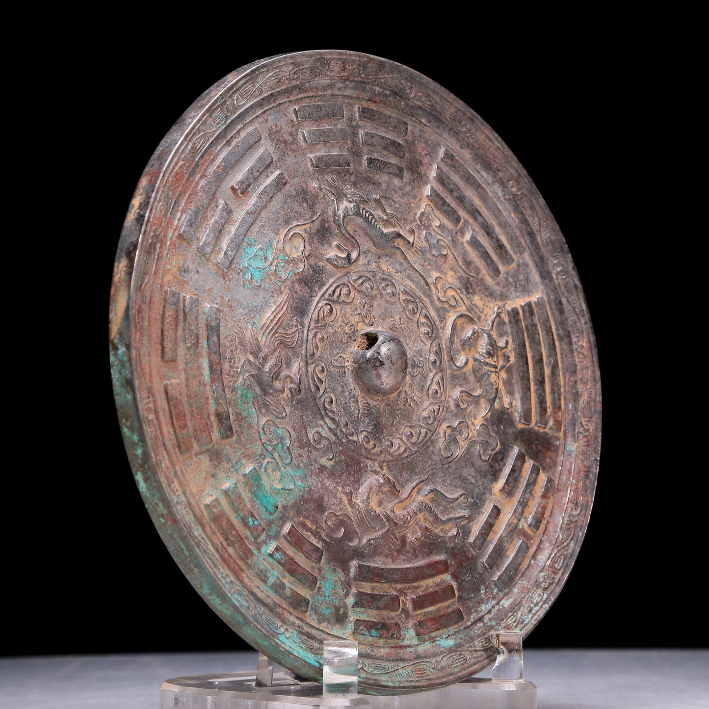 An Archaic Circular Bronze 'Auspicious Beast, Auspicious Cloud, The Eight Diagrams' Mirror