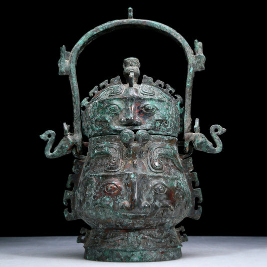 An Archaic Bronze 'Animal Mask' Pot With Inscriptions And An Overhead Handle