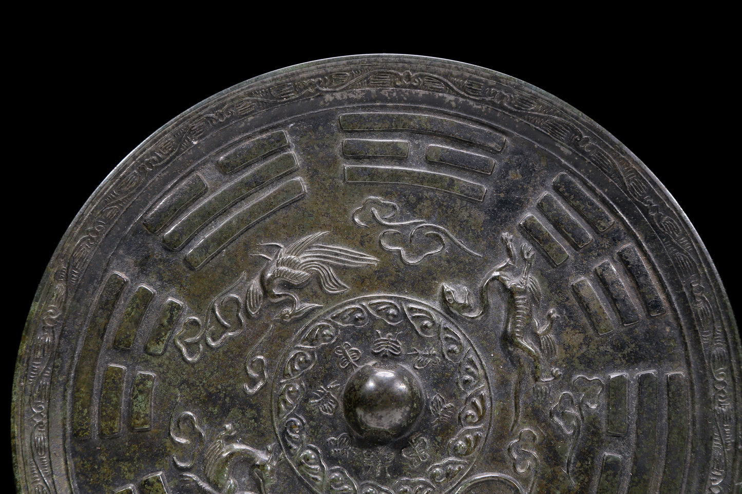 An Archaic Circular Bronze 'Auspicious Beast, Auspicious Cloud, The Eight Diagrams' Mirror