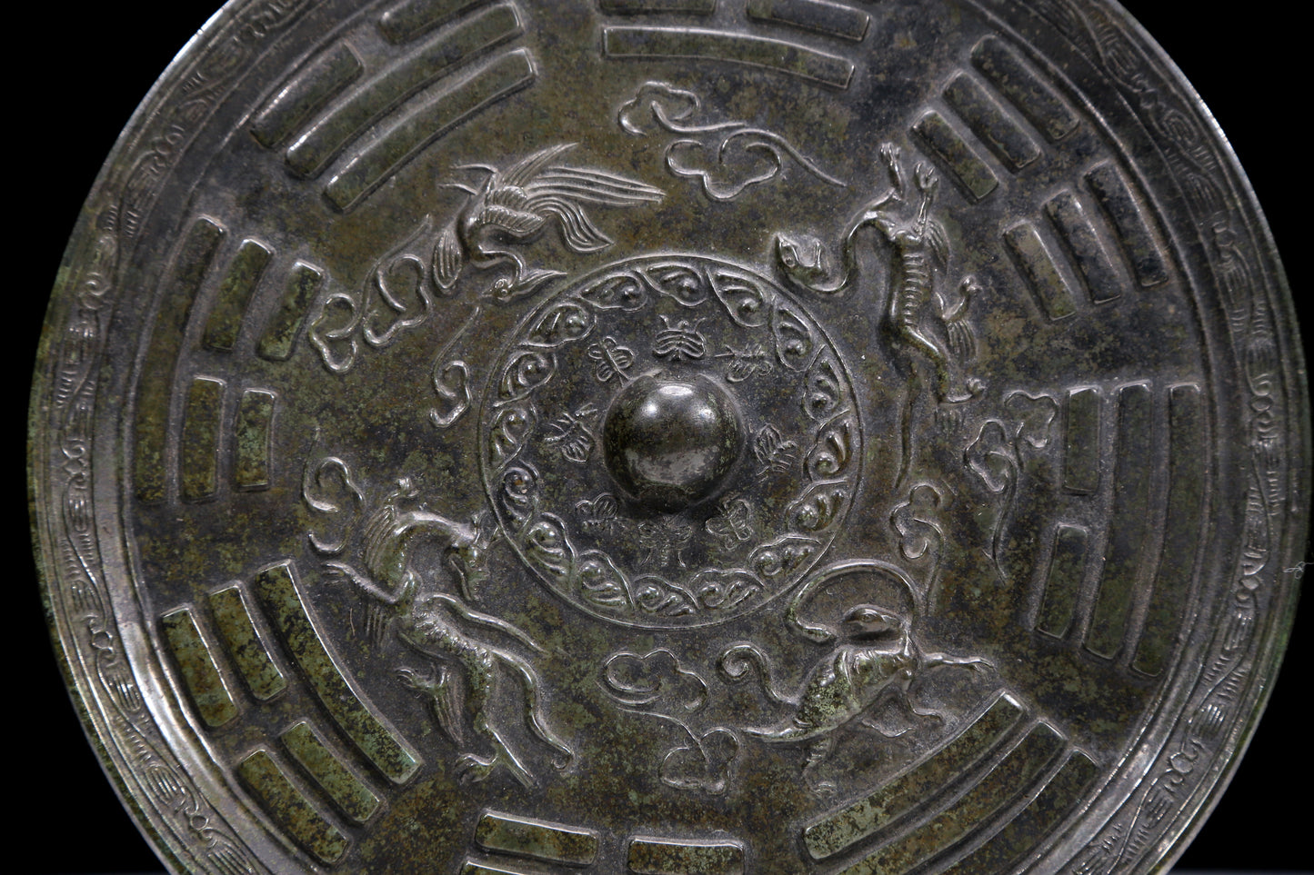 An Archaic Circular Bronze 'Auspicious Beast, Auspicious Cloud, The Eight Diagrams' Mirror