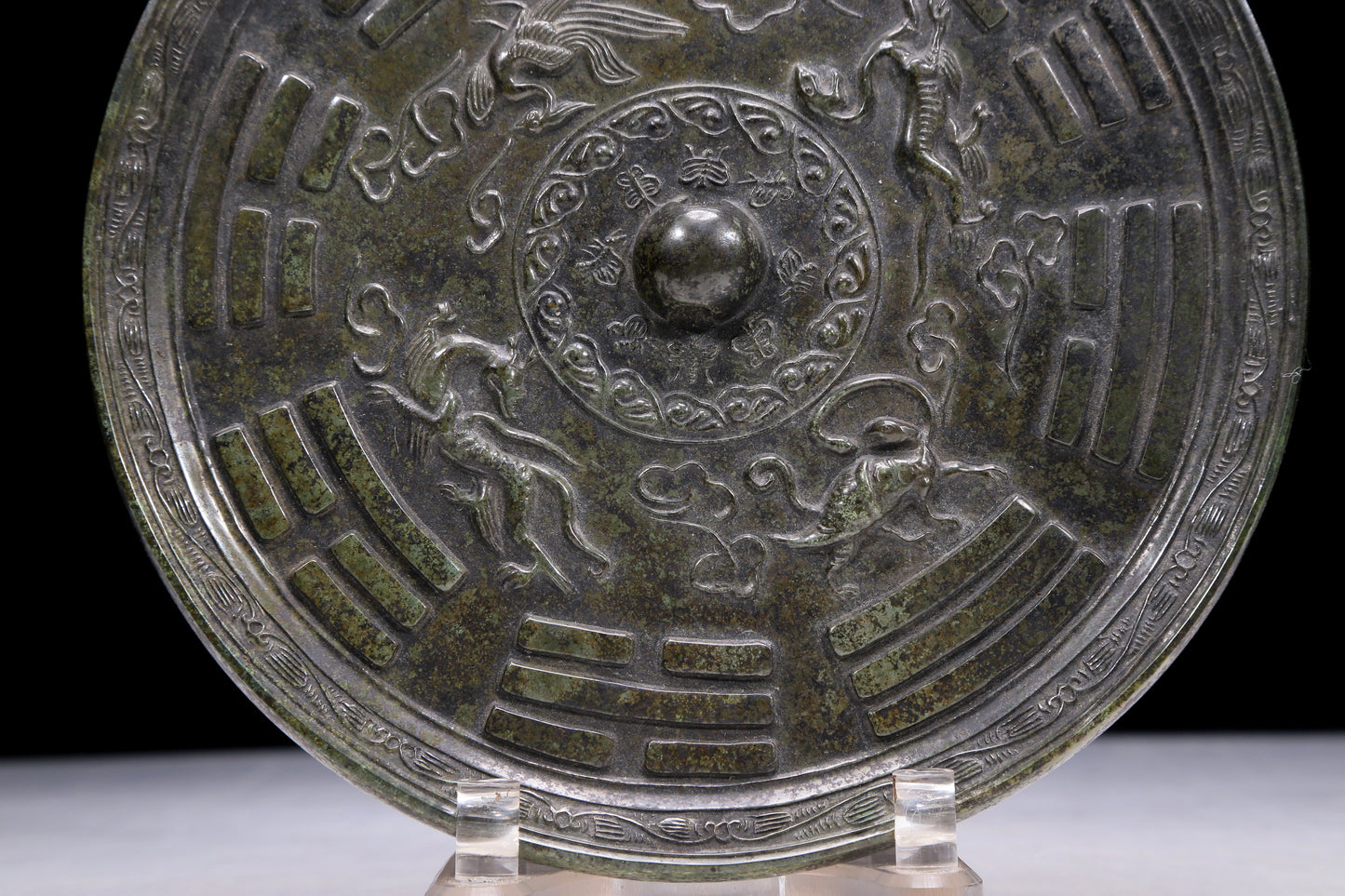 An Archaic Circular Bronze 'Auspicious Beast, Auspicious Cloud, The Eight Diagrams' Mirror