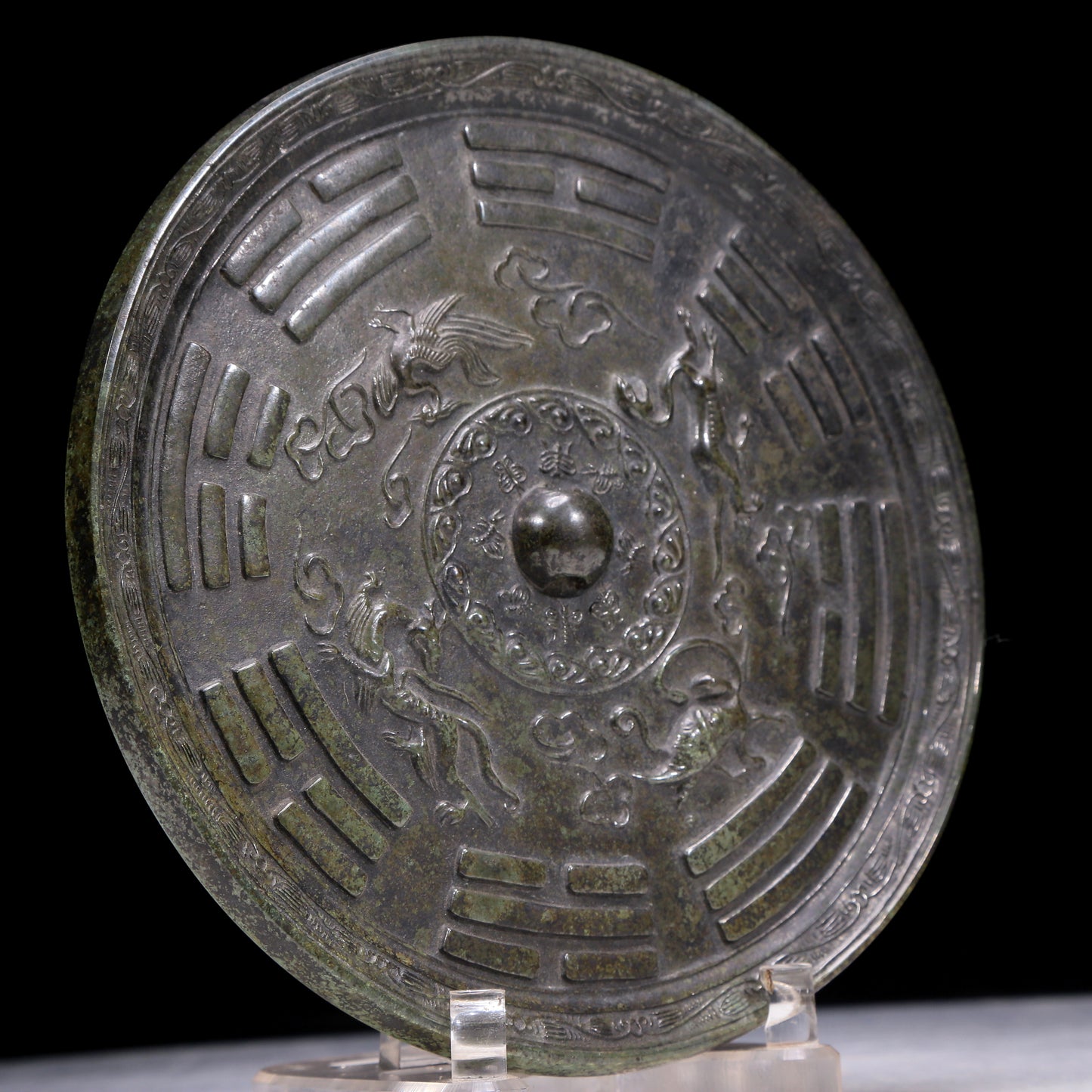 An Archaic Circular Bronze 'Auspicious Beast, Auspicious Cloud, The Eight Diagrams' Mirror