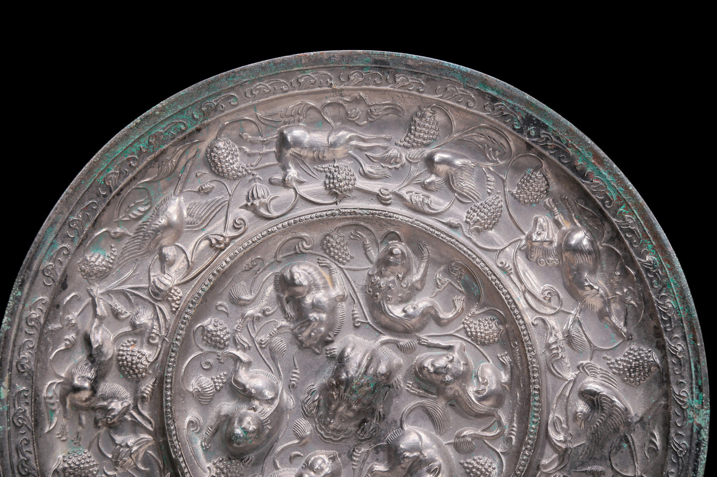 An Archaic Circular Silver-Bronze 'Flower& Auspicious Beast' Mirror