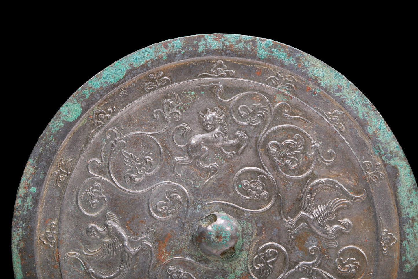 An Archaic Circular Bronze 'Flower& Auspicious Beast' Mirror