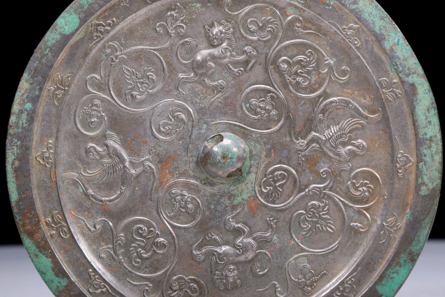 An Archaic Circular Bronze 'Flower& Auspicious Beast' Mirror