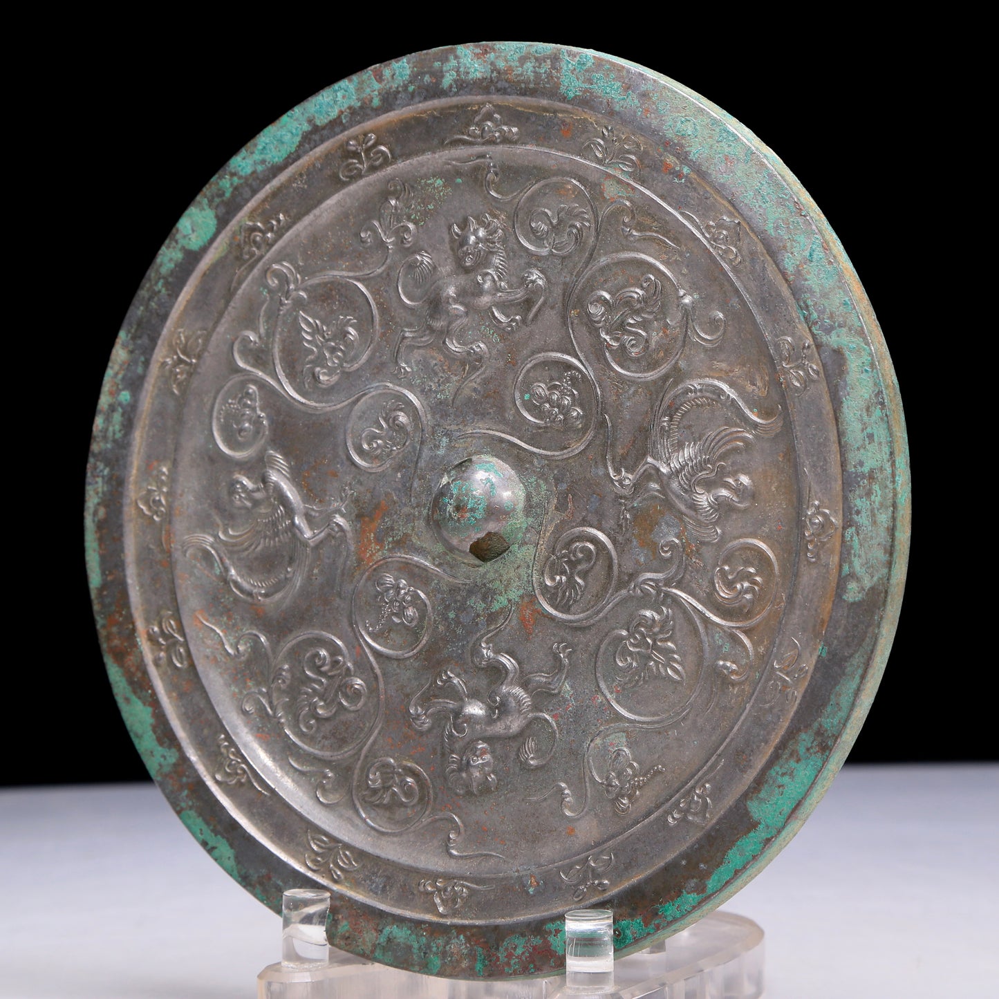 An Archaic Circular Bronze 'Flower& Auspicious Beast' Mirror