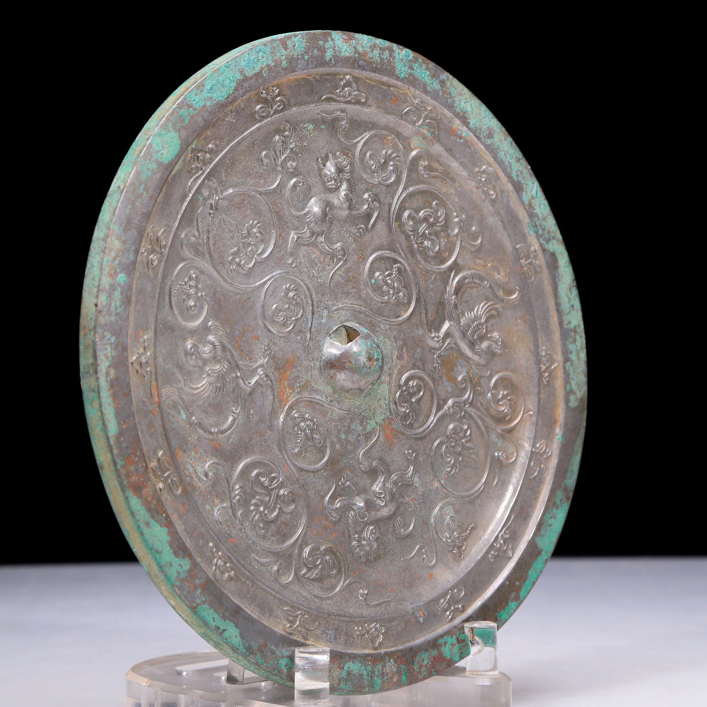 An Archaic Circular Bronze 'Flower& Auspicious Beast' Mirror