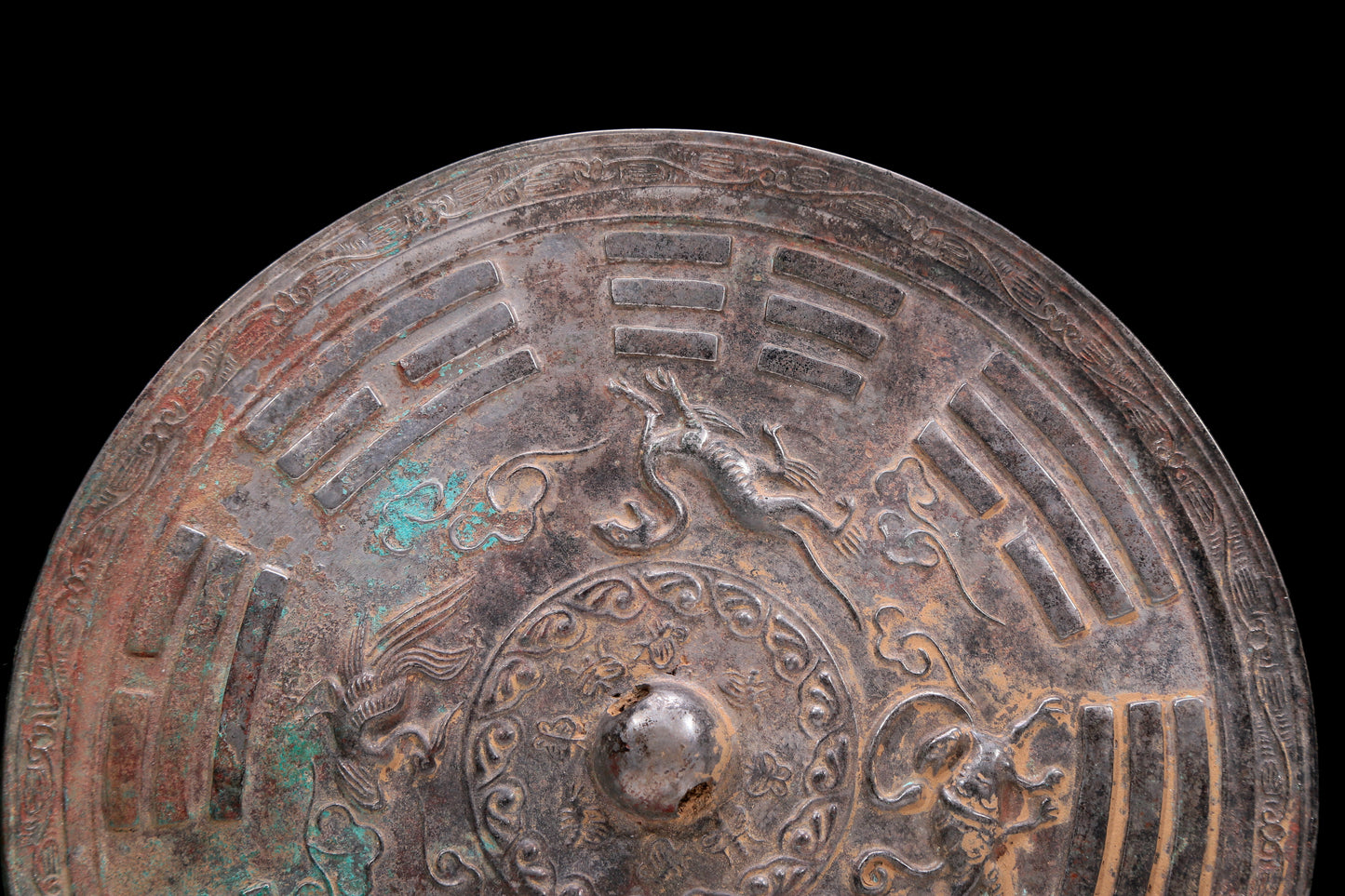 An Archaic Circular Bronze 'Auspicious Beast, Auspicious Cloud, The Eight Diagrams' Mirror